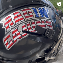 A black motorcycle helmet with the text "Ragin' Cajuns" on it in red white and blue
